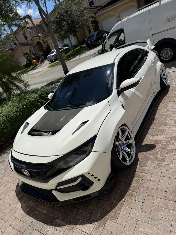 White Honda Civic Type R with carbon hood, freshly detailed on brick pavers