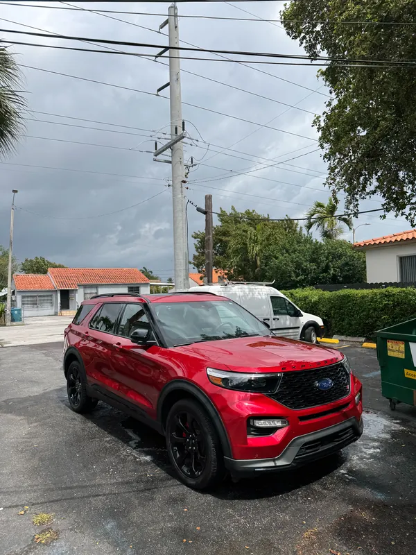 Red Ford Explorer ST with glossy paint and dressed tires after an exterior detail