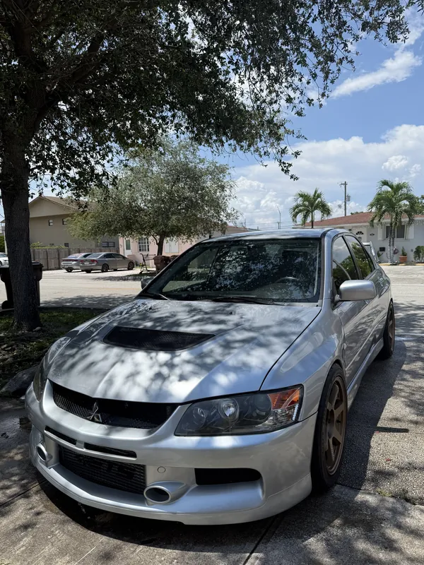 Silver Mitsubishi Lancer Evolution with carbon hood, cleaned and detailed