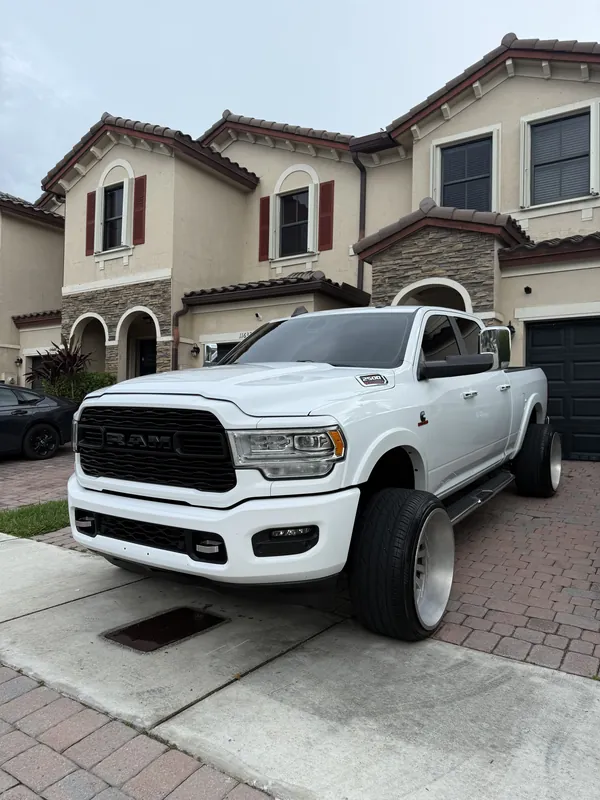 White RAM pickup truck freshly detailed in front of a Miami townhouse